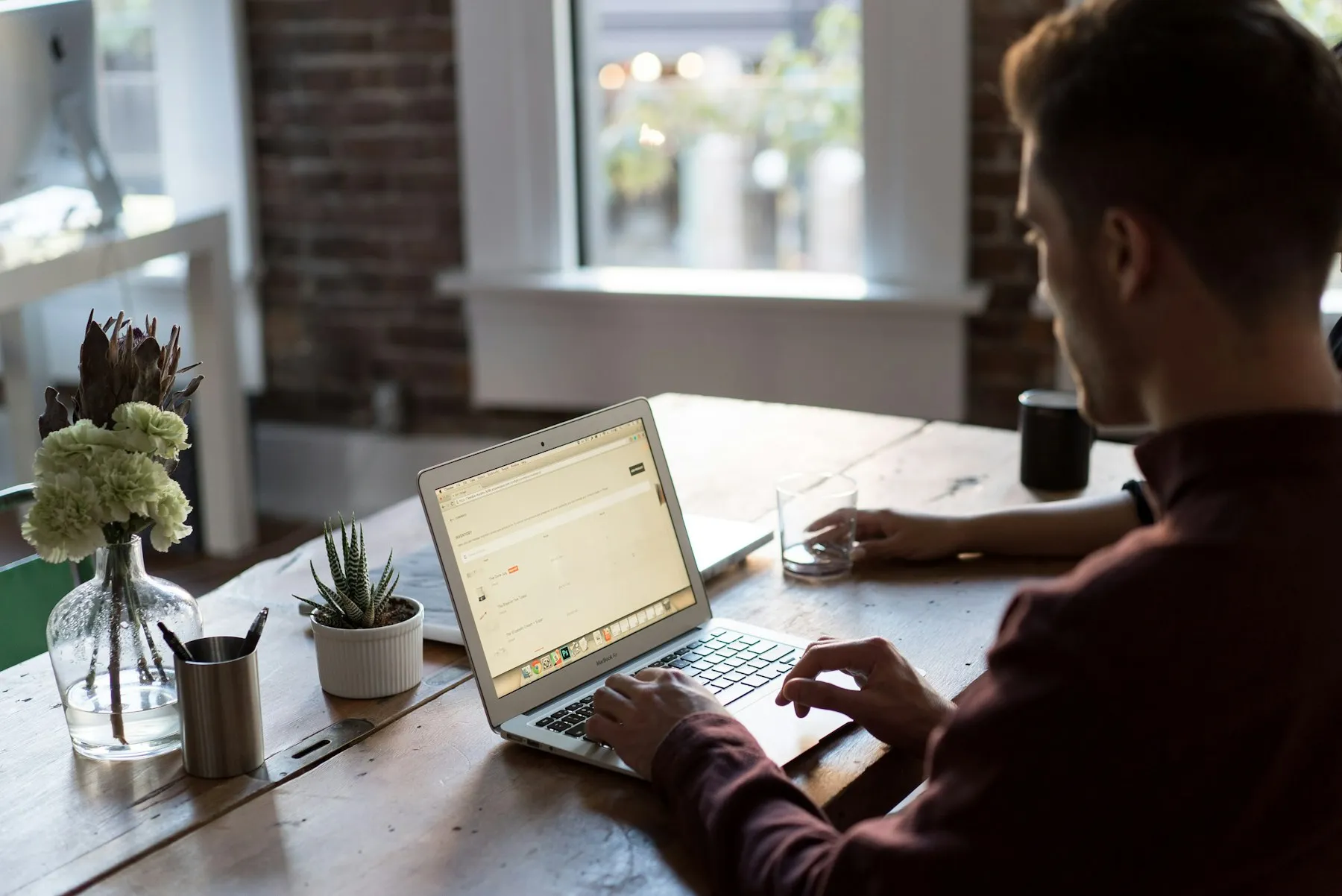A bookkeeper working through client records on a laptop